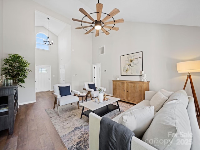 4101 New Castle Ln, Monroe, NC 28110 - living room featuring wood-type flooring, high vaulted ceiling, a ceiling fan, a chandelier, and baseboards