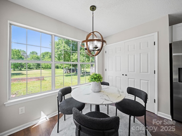 4101 New Castle Ln, Monroe, NC 28110 - dining area featuring a chandelier, baseboards, dark wood-style floors, and a textured ceiling