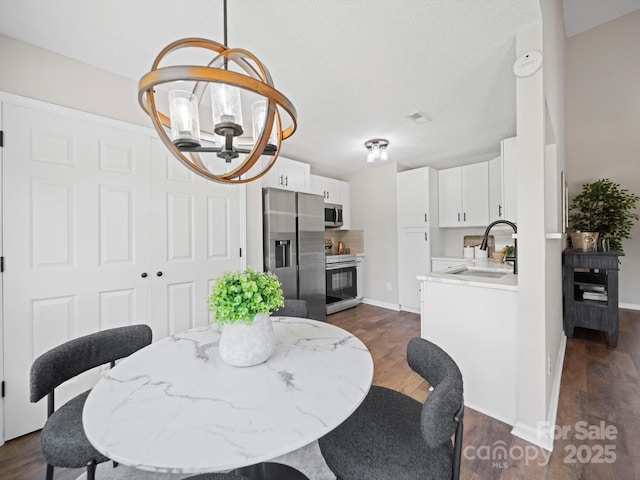 4101 New Castle Ln, Monroe, NC 28110 - dining room with a chandelier, dark wood-type flooring, and baseboards