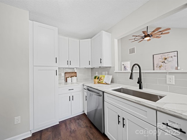 4101 New Castle Ln, Monroe, NC 28110 - kitchen featuring stainless steel dishwasher, a sink, tasteful backsplash, dark wood-type flooring, and a textured ceiling