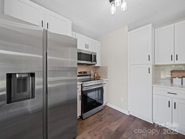 4101 New Castle Ln, Monroe, NC 28110 - kitchen with stainless steel appliances, dark wood-type flooring, light countertops, white cabinets, and a textured ceiling