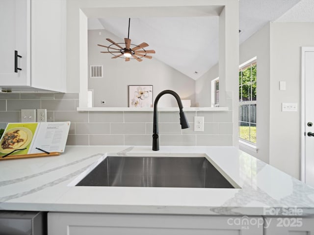 4101 New Castle Ln, Monroe, NC 28110 - kitchen with a sink, tasteful backsplash, lofted ceiling, white cabinets, and ceiling fan