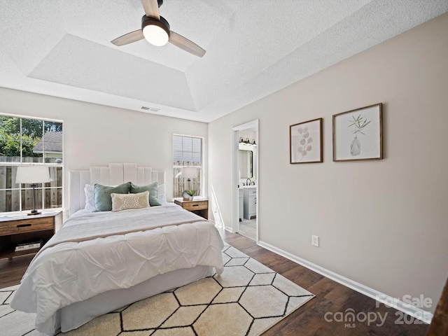 4101 New Castle Ln, Monroe, NC 28110 - bedroom featuring a raised ceiling, wood finished floors, baseboards, a ceiling fan, and ensuite bathroom