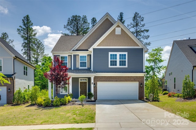 craftsman house with a garage, concrete driveway, and a front lawn