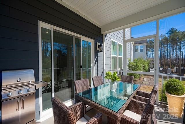 1540 Striped Bass Ln, Clover, SC 29710 - sunroom with outdoor dining area and wood walls