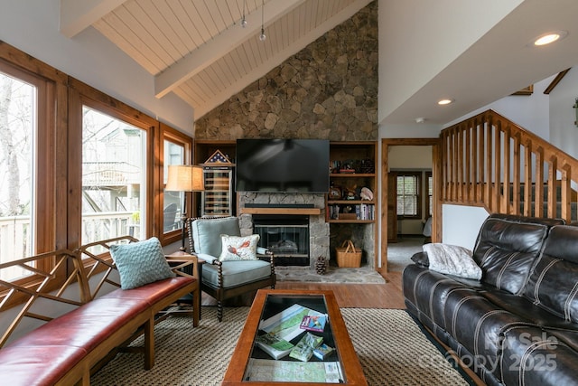 living area with a fireplace, beamed ceiling, wood finished floors, recessed lighting, and high vaulted ceiling