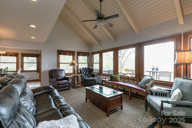 living room featuring beam ceiling, high vaulted ceiling, recessed lighting, a ceiling fan, and a chandelier