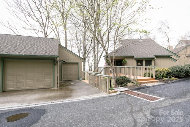 view of front of home featuring a shingled roof and a garage