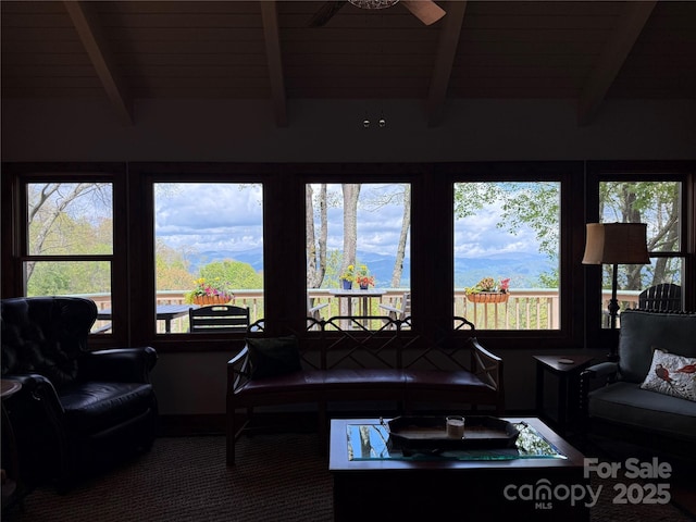 carpeted living room with beam ceiling and ceiling fan