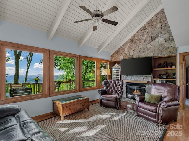 141 Ivy Ridge Rd, Burnsville, NC 28714 - living area featuring wood finished floors, wooden ceiling, a ceiling fan, a fireplace, and baseboards
