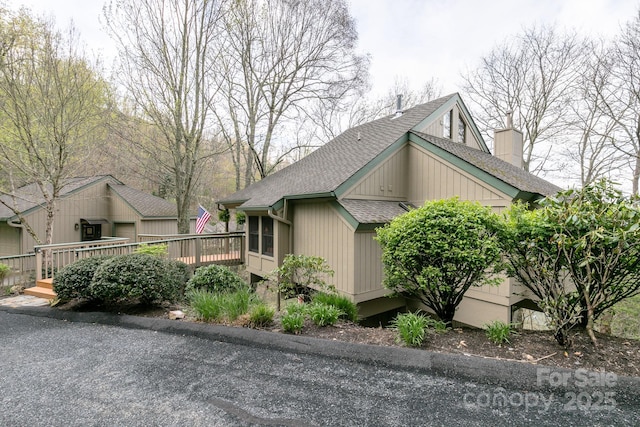 141 Ivy Ridge Rd, Burnsville, NC 28714 - view of property exterior featuring roof with shingles, a deck, and a chimney