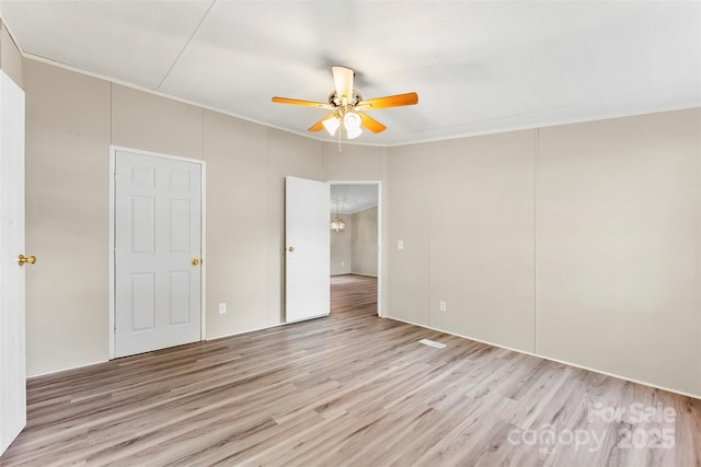unfurnished bedroom with crown molding, ceiling fan, and wood finished floors