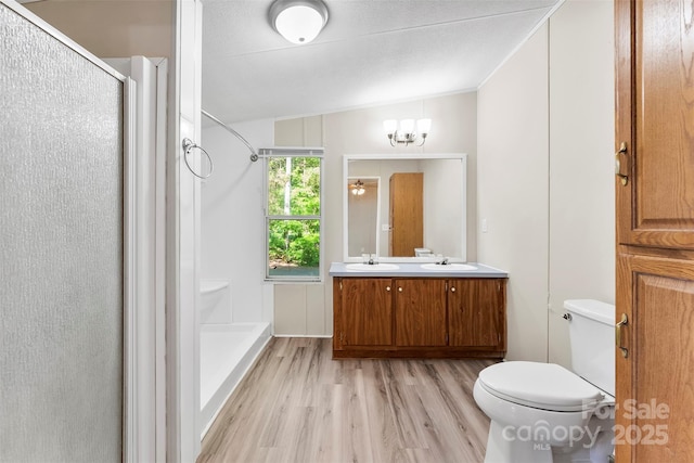 full bath featuring a sink, wood finished floors, and a shower stall
