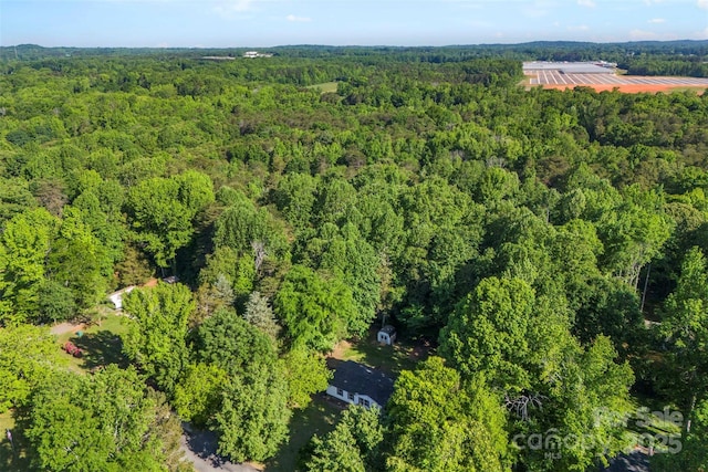 birds eye view of property with a forest view