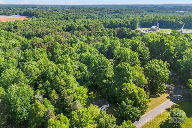drone / aerial view featuring a forest view