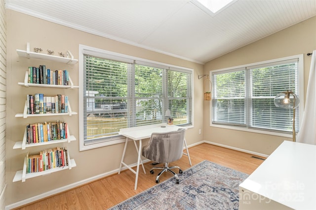 office with wood finished floors, baseboards, vaulted ceiling, and crown molding