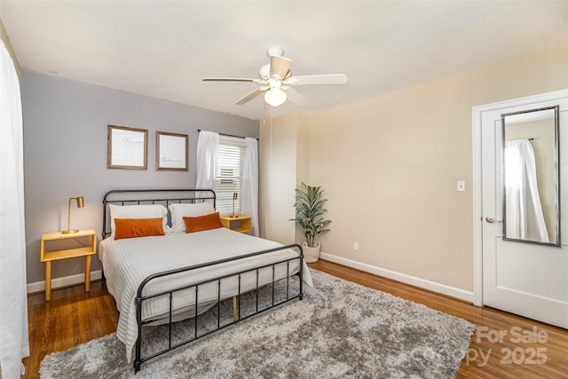 bedroom with wood finished floors, baseboards, and a ceiling fan