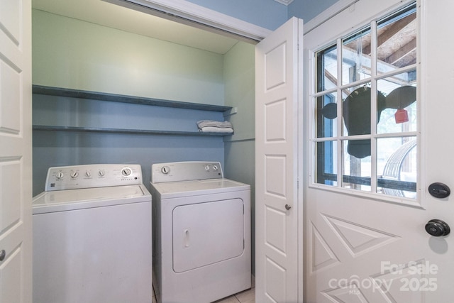 laundry room with washing machine and dryer and plenty of natural light