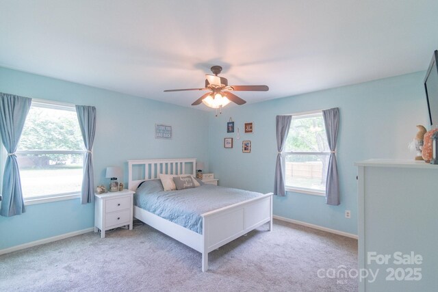 carpeted bedroom featuring a ceiling fan and baseboards