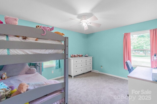 carpeted bedroom featuring baseboards and ceiling fan