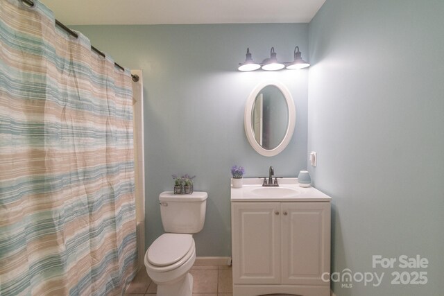 full bathroom featuring tile patterned flooring, vanity, toilet, and a shower with shower curtain