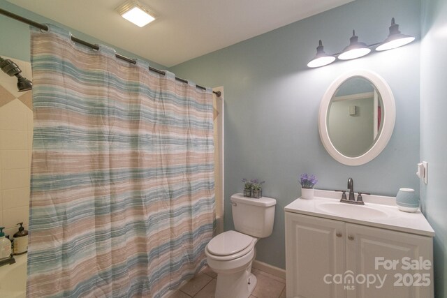 full bathroom with tile patterned floors, toilet, a shower with shower curtain, and vanity