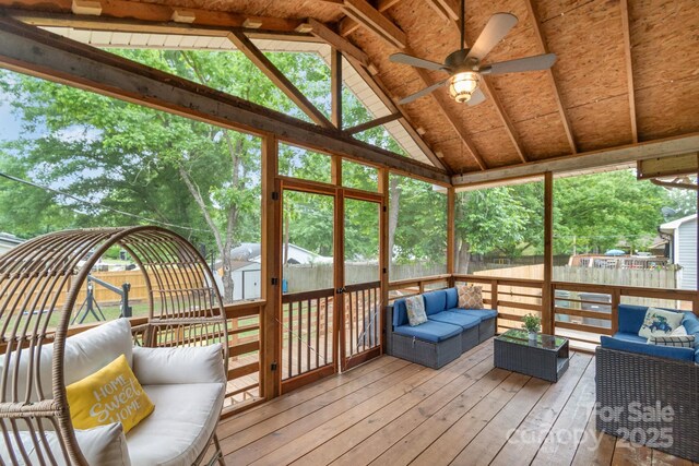 sunroom / solarium featuring outdoor lounge area, vaulted ceiling, and ceiling fan