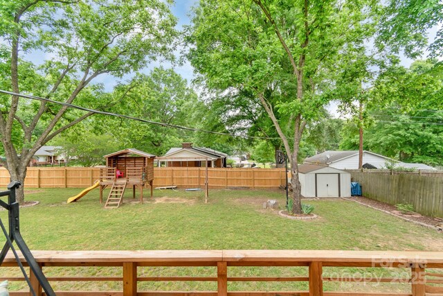 view of yard with a playground, a storage shed, and an outdoor structure