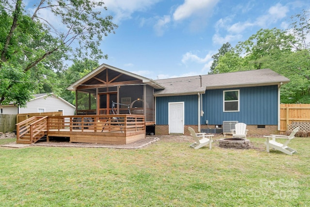 rear view of house with a sunroom, an outdoor fire pit, a deck, crawl space, and cooling unit