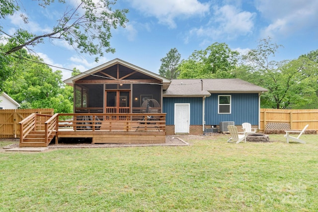 back of property featuring a fire pit, a sunroom, a wooden deck, board and batten siding, and a shingled roof
