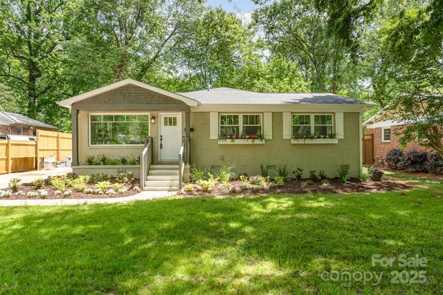single story home with fence, a front lawn, and brick siding