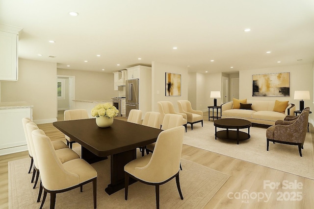 dining area with recessed lighting, light wood-style floors, and baseboards