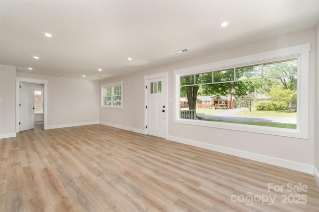 unfurnished living room with light wood-style floors, baseboards, and recessed lighting