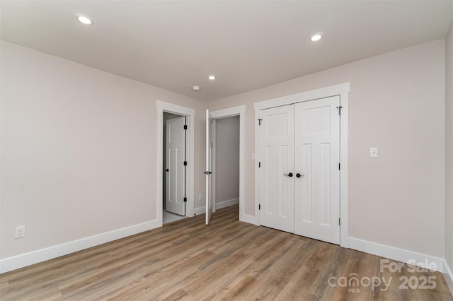 unfurnished bedroom featuring recessed lighting, baseboards, and light wood-style floors