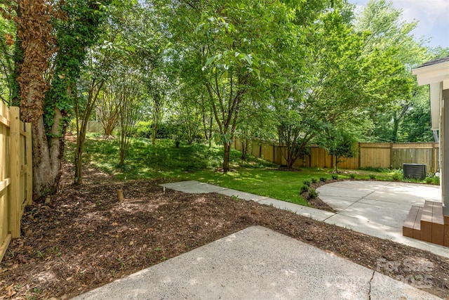 view of yard featuring a fenced backyard, cooling unit, and a patio area