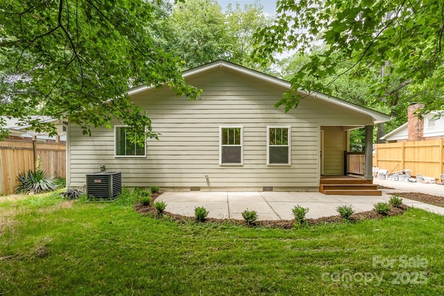 rear view of property with a yard, a patio, fence, and cooling unit