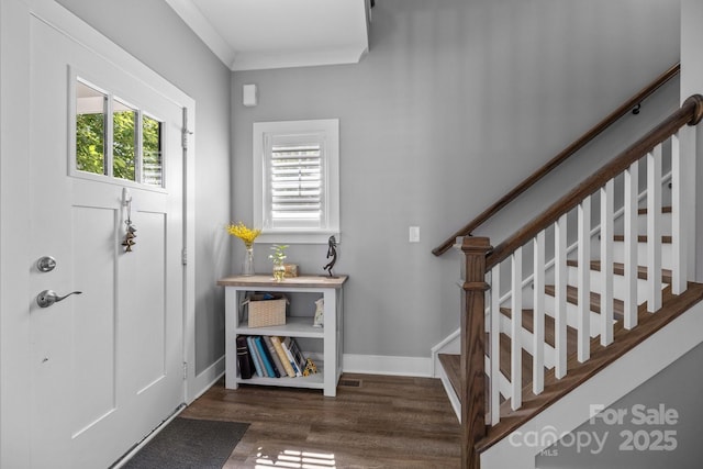 foyer entrance with stairway, wood finished floors, and baseboards