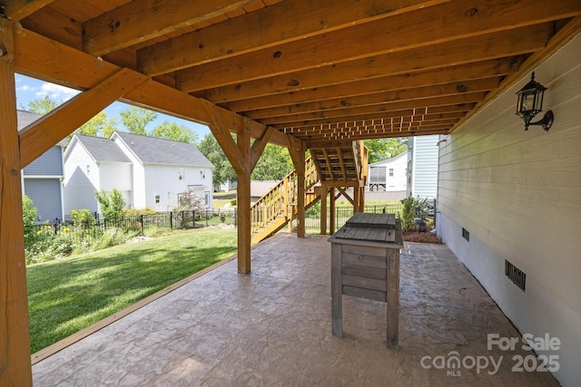 view of patio / terrace featuring stairs, a residential view, and a fenced backyard