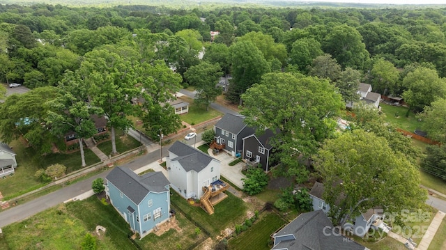 birds eye view of property featuring a forest view and a residential view