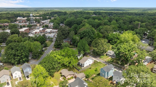 birds eye view of property with a forest view and a residential view