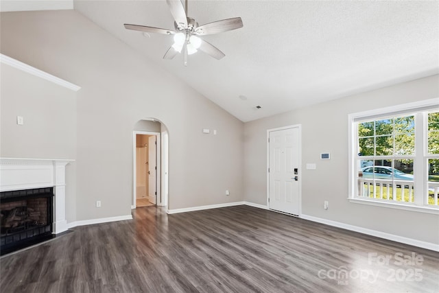 unfurnished living room featuring high vaulted ceiling, baseboards, arched walkways, ceiling fan, and dark wood-style floors