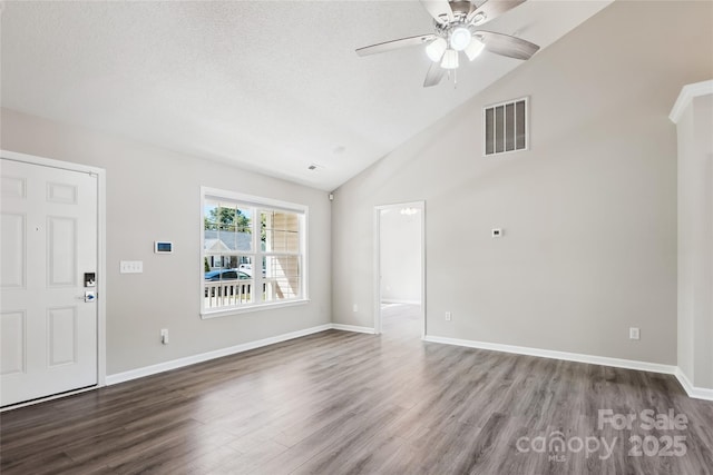 unfurnished living room with ceiling fan, wood finished floors, high vaulted ceiling, baseboards, and a textured ceiling