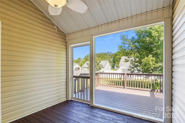 unfurnished sunroom with a ceiling fan