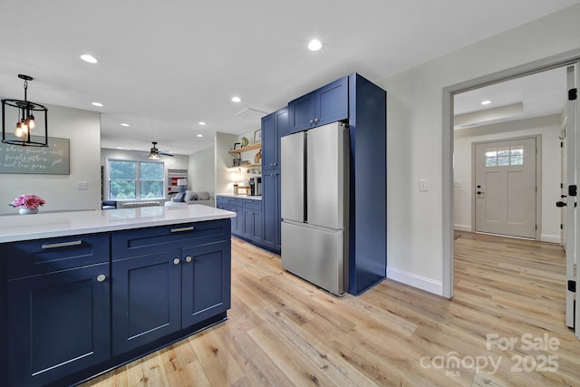 456 Rainbow Cir, Clover, SC 29710 - kitchen featuring freestanding refrigerator, blue cabinetry, light wood-type flooring, light countertops, and recessed lighting