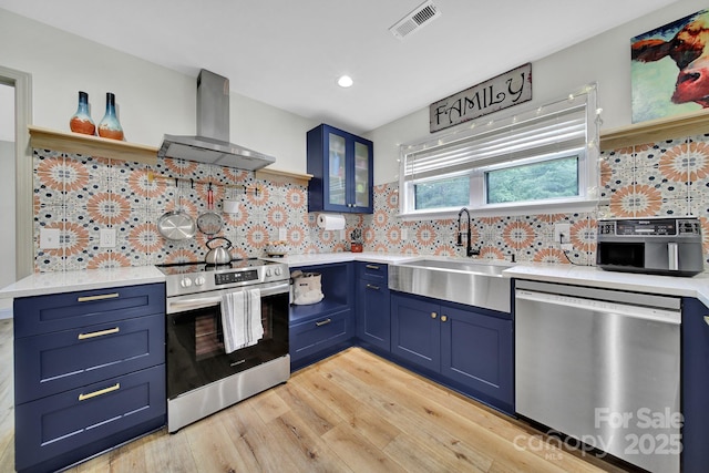 456 Rainbow Cir, Clover, SC 29710 - kitchen with appliances with stainless steel finishes, island exhaust hood, a sink, blue cabinets, and recessed lighting