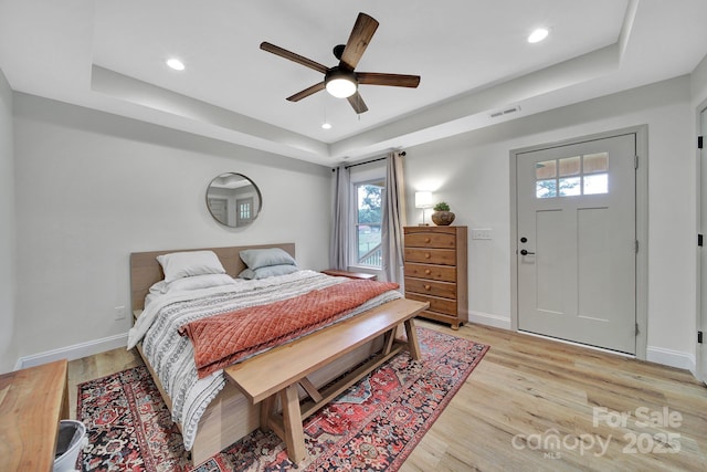 456 Rainbow Cir, Clover, SC 29710 - bedroom with a tray ceiling, multiple windows, light wood finished floors, baseboards, and recessed lighting