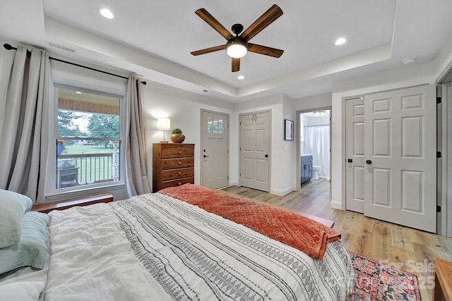 456 Rainbow Cir, Clover, SC 29710 - bedroom with light wood-style floors, a raised ceiling, recessed lighting, baseboards, and ensuite bathroom