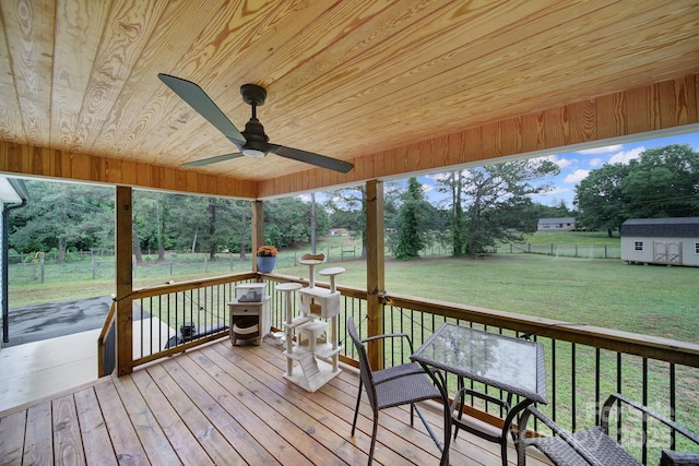 456 Rainbow Cir, Clover, SC 29710 - wooden deck featuring ceiling fan, view of scattered trees, an outdoor structure, and a storage shed