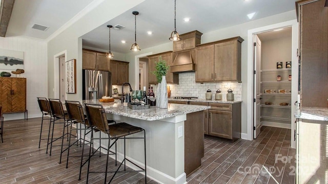 kitchen featuring visible vents, appliances with stainless steel finishes, and dark wood-style floors