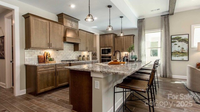 kitchen featuring visible vents, decorative backsplash, appliances with stainless steel finishes, and dark wood-style floors